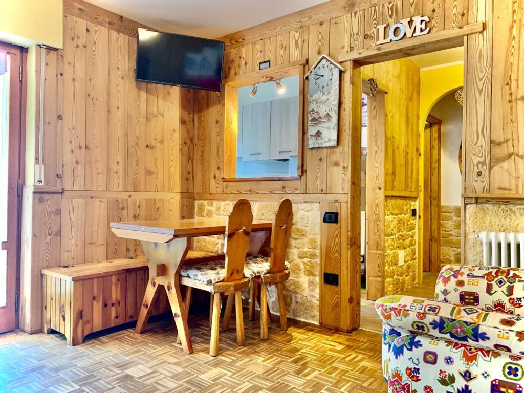 a dining room with a table and two chairs at Profumo di Legno in Valtournenche