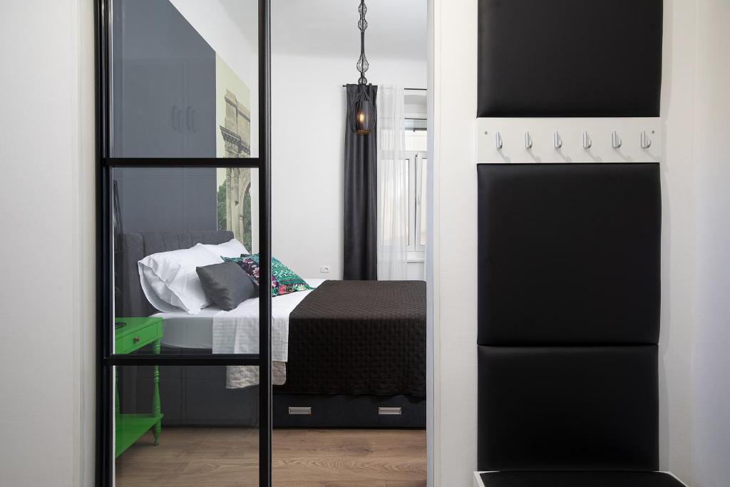 a bedroom with a bed and a mirror at Apartment Deluxe Ana in Pula