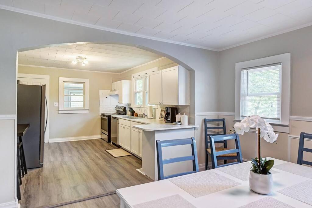 a kitchen with a table and two blue chairs at 3BR/2 Bath with King and outside fire Pit in Concord