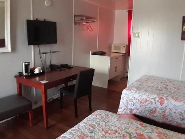 a room with a desk and a bed and a room with a desk at Regal Motel in Timmins