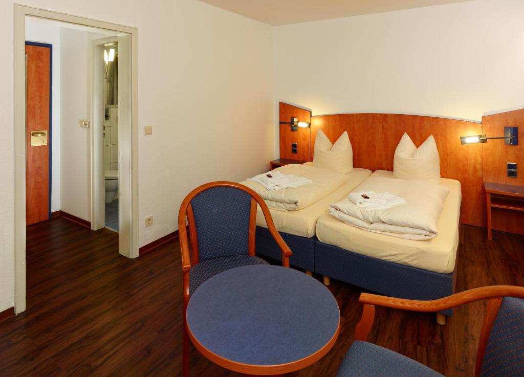 Postel nebo postele na pokoji v ubytování Hotel Stadt Daun