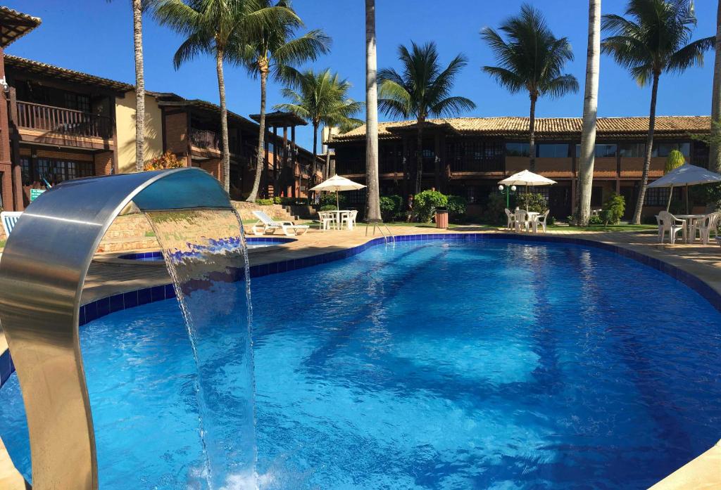 a large swimming pool with a water fountain at Geribá Shark House in Búzios