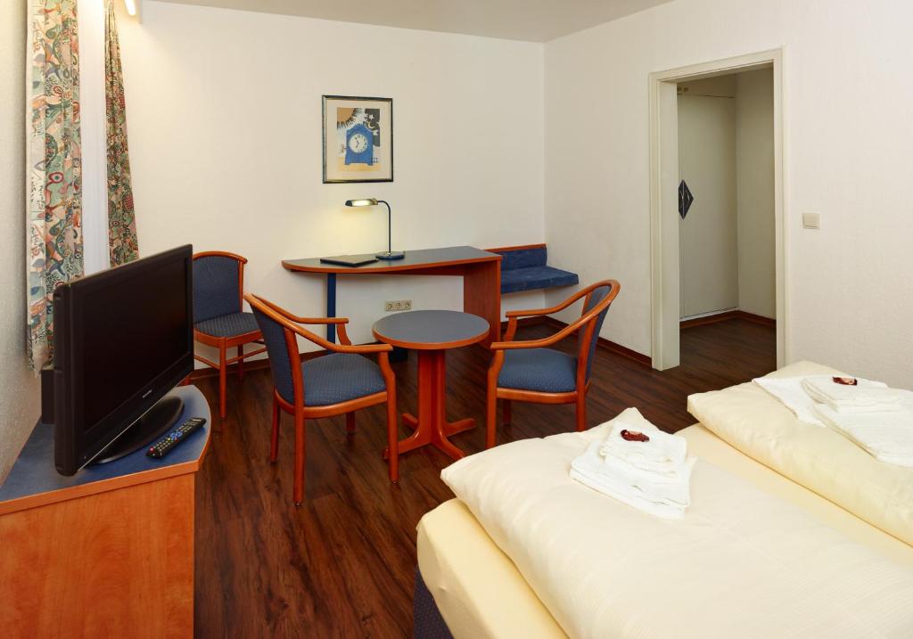 Postel nebo postele na pokoji v ubytování Hotel Stadt Daun