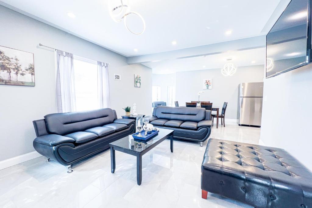 a living room with two blue couches and a table at The Cedar Chateau in Niagara Falls