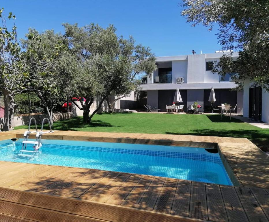 a swimming pool in front of a building at Greek Dream Homes Thimari in Sounio