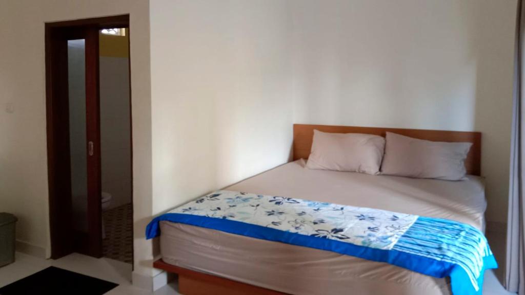 Postel nebo postele na pokoji v ubytování Nova Homestay Ubud