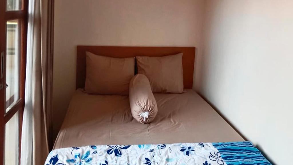 Postel nebo postele na pokoji v ubytování Nova Homestay Ubud