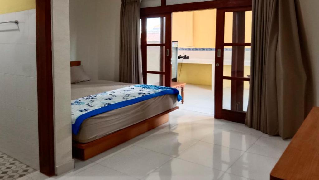 Postel nebo postele na pokoji v ubytování Nova Homestay Ubud