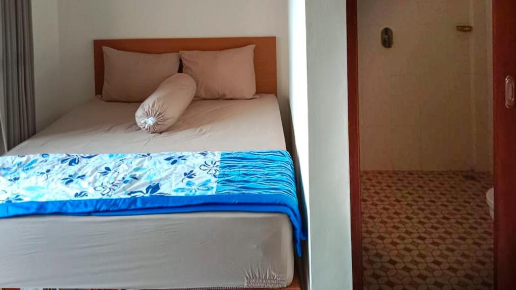 Postel nebo postele na pokoji v ubytování Nova Homestay Ubud