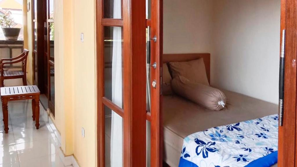 Postel nebo postele na pokoji v ubytování Nova Homestay Ubud
