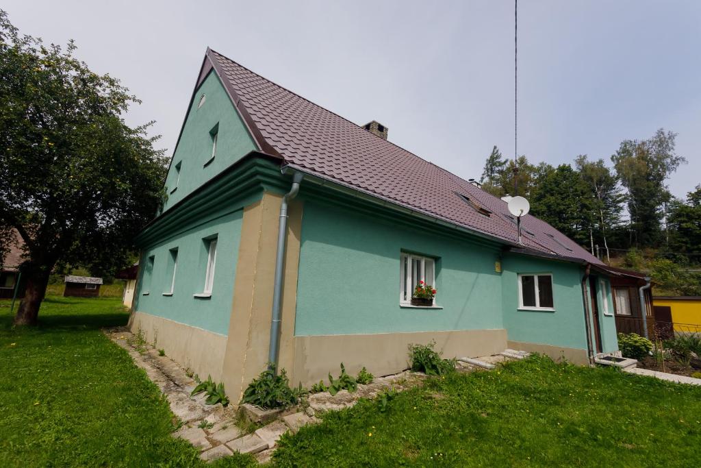 una casa azul con techo marrón en Chata Lomnice U Potoka, en Lomnice