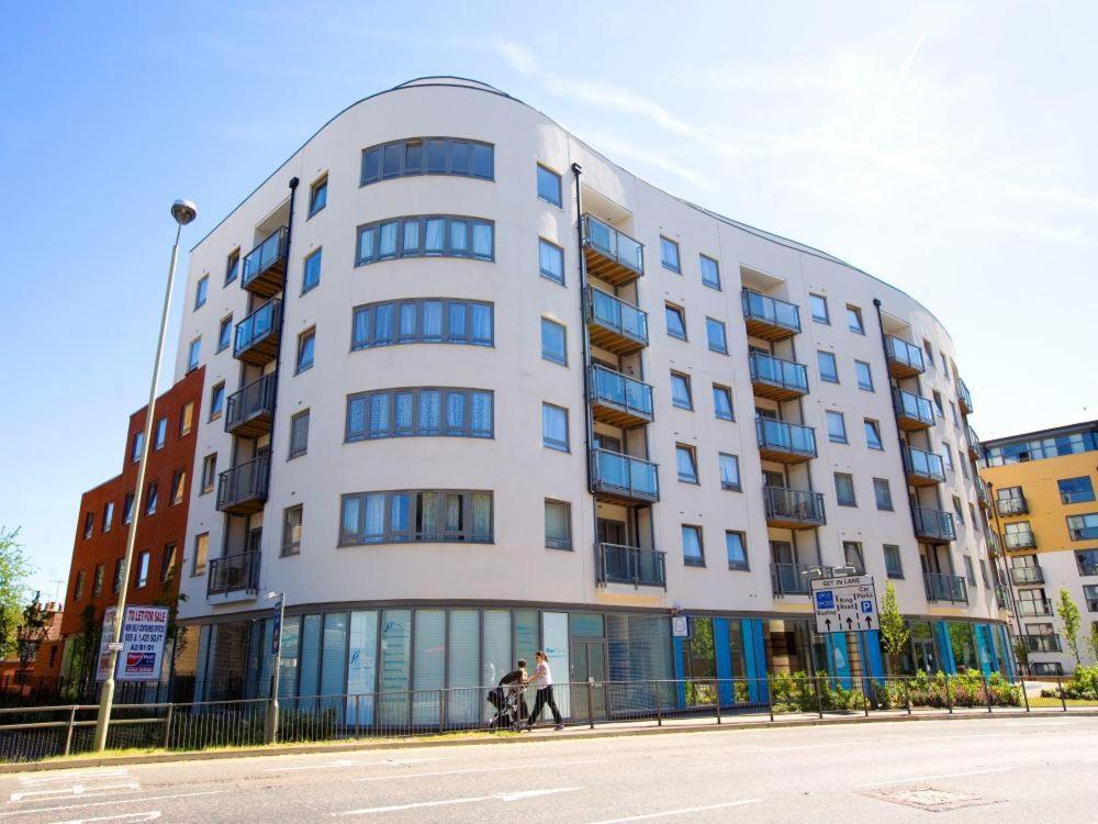 a white building with people walking in front of it at 2 bedroom & 2 bathroom apartment - TcA58 in Watford