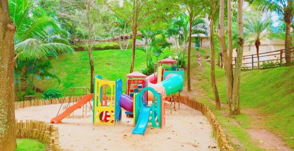 a playground with a slide in a park at Thermas Paradise Apart in Rio Quente