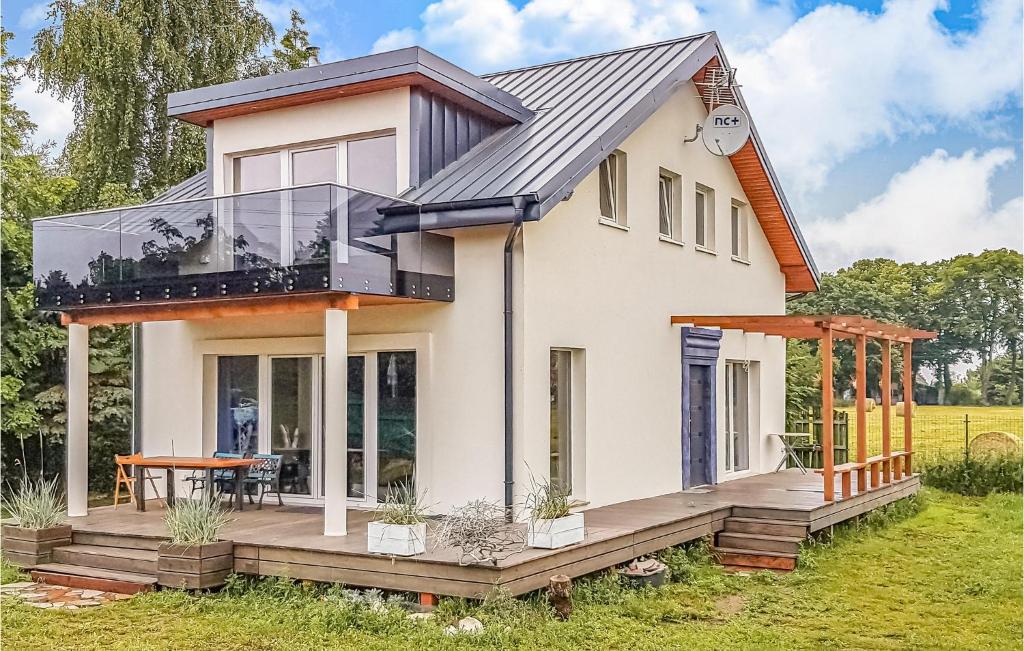a house with a glass roof and a deck at Beautiful Home In Nowe Warpno With Wifi in Nowe Warpno