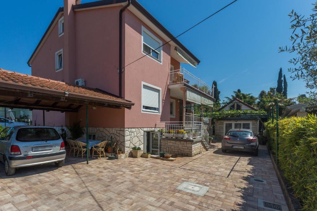 a house with a car parked in a driveway at Apartment Umag 7063b in Umag