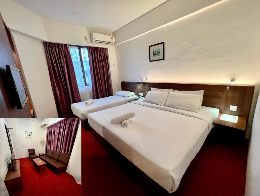 a hotel room with two beds and a red carpet at Hotel Yt Midtown Kuala Terengganu in Kuala Terengganu