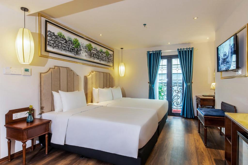 Postel nebo postele na pokoji v ubytování Hanoi Calista Hotel & Spa