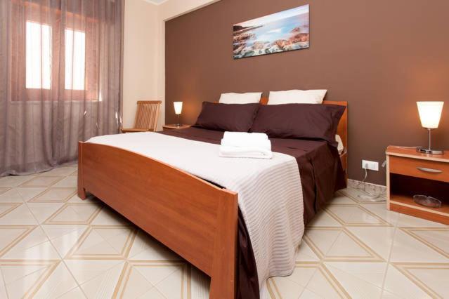 a bedroom with a large bed in a room at Il Terrazzo Di Oleandri in Bagheria