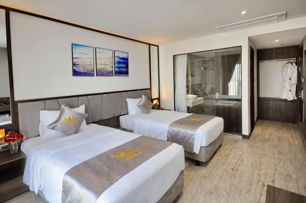 Giường trong phòng chung tại Ivy Hotel Nha Trang