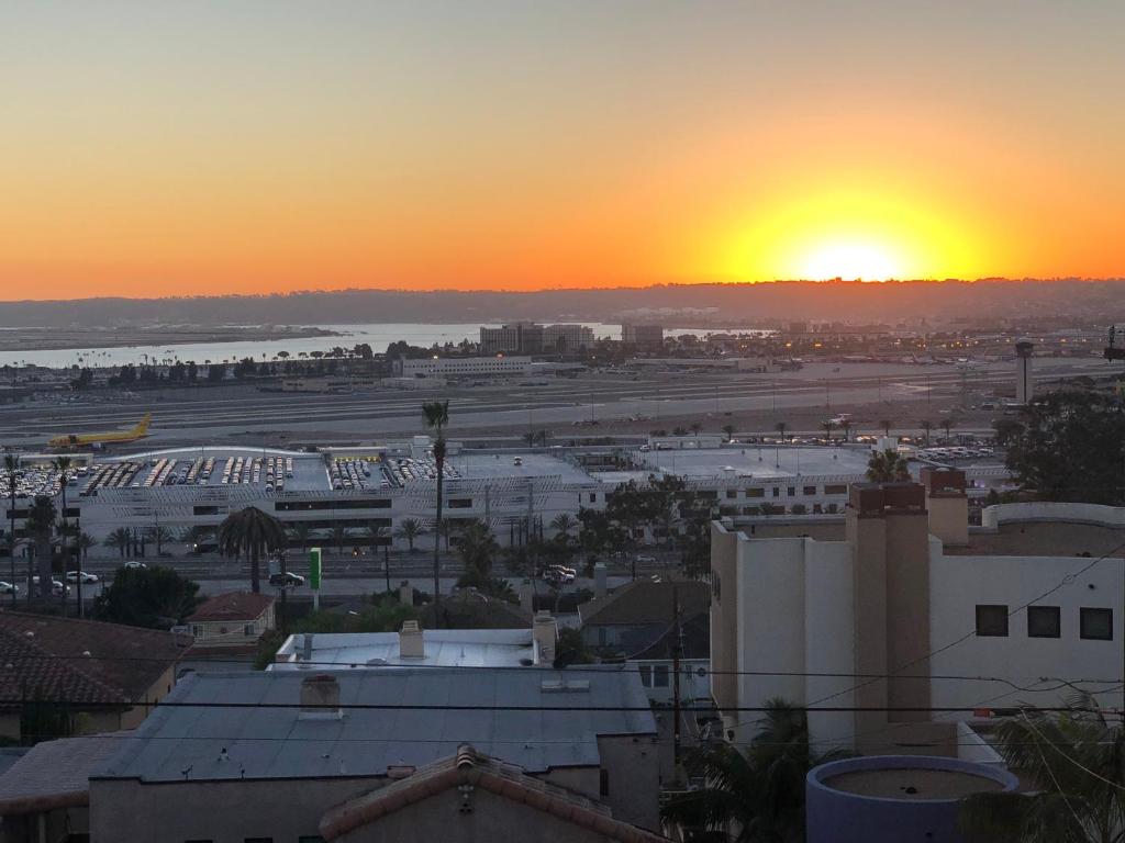 a view of a city with the sunset in the background at OCEAN VIEW - entire home - Excellent location in San Diego