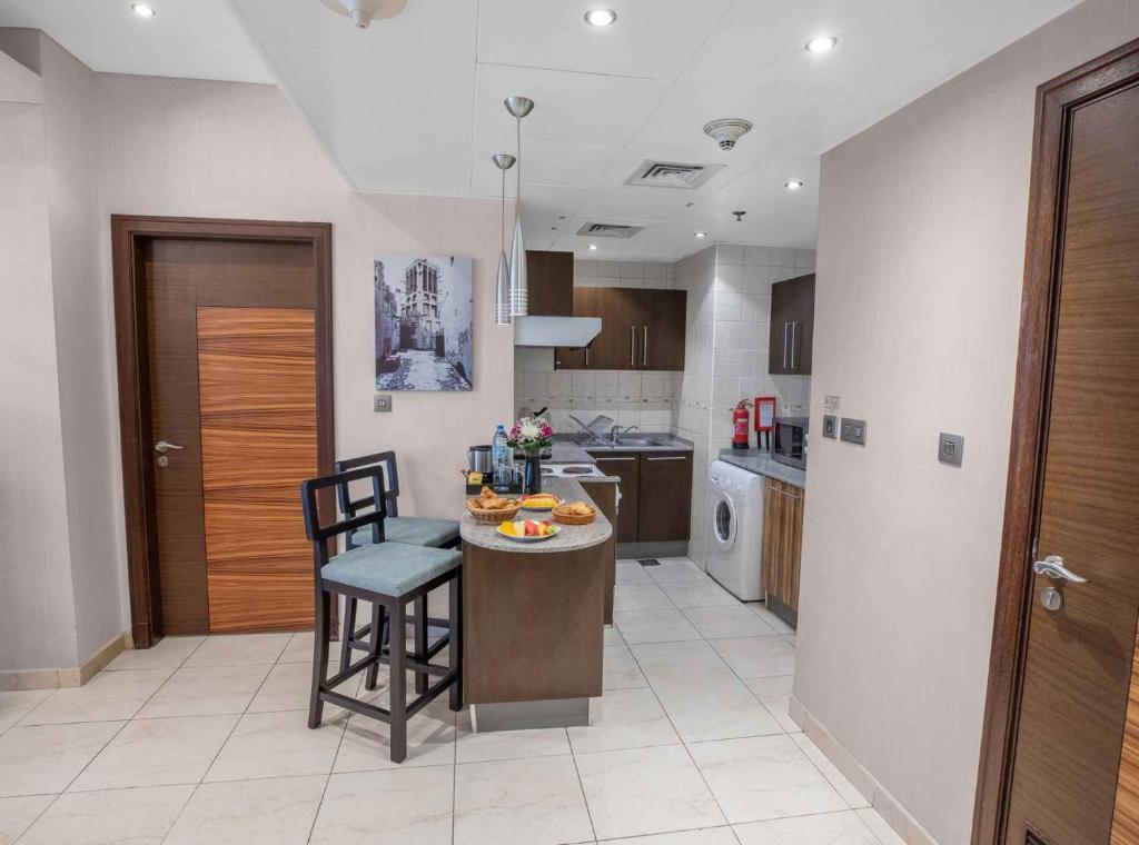 a kitchen with a small island in the middle at City Premiere Hotel Apartments - Dubai in Dubai