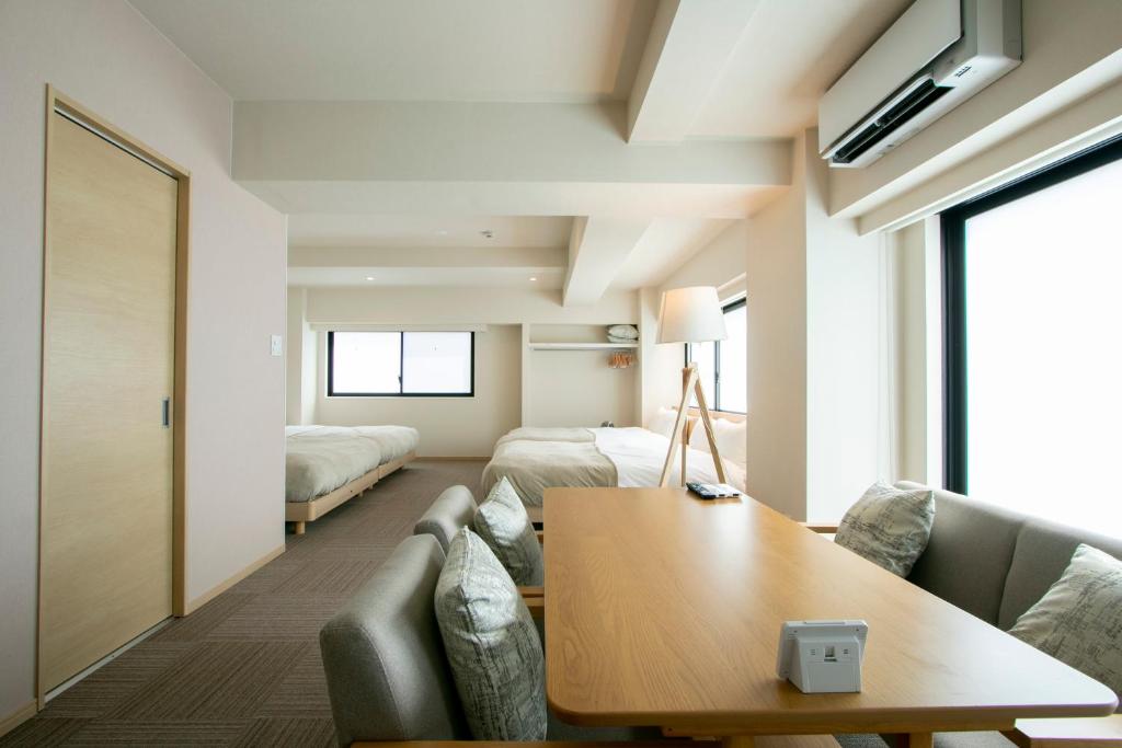 a living room with a couch and a table at Ostay Ueno in Tokyo