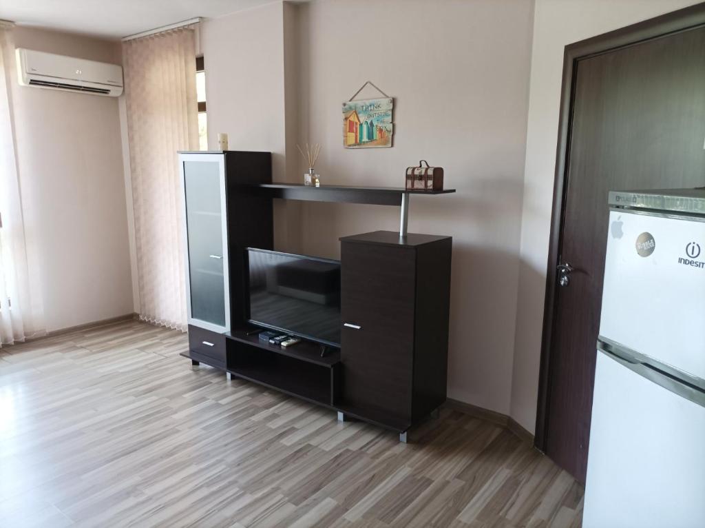 a living room with a tv and a black entertainment center at One Bedroom Apartment 10 - Vasil Aprilov 64 Plovdiv in Plovdiv