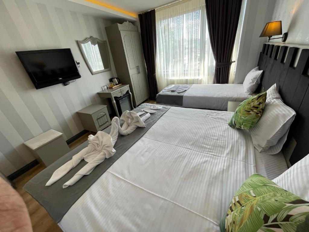 Postel nebo postele na pokoji v ubytování Old City Viva Hotel