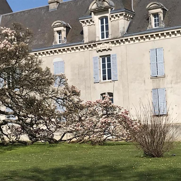 a large house with a tree in front of it at Chambres d&#39;Hôtes Bienvenue in LʼAbsie