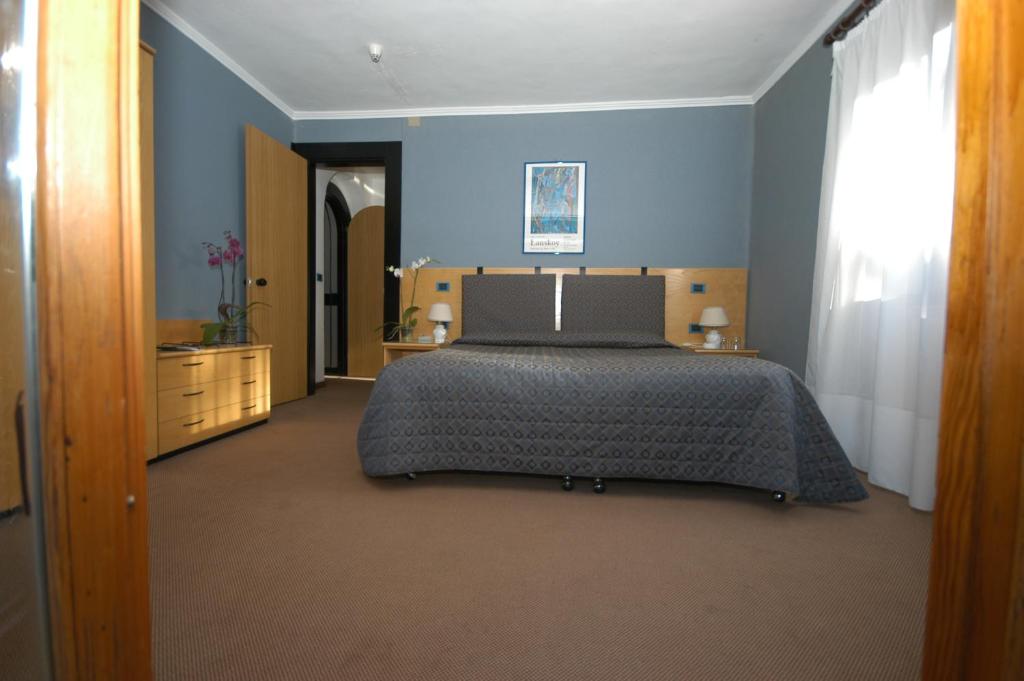 Postel nebo postele na pokoji v ubytování Hotel Des Geneys