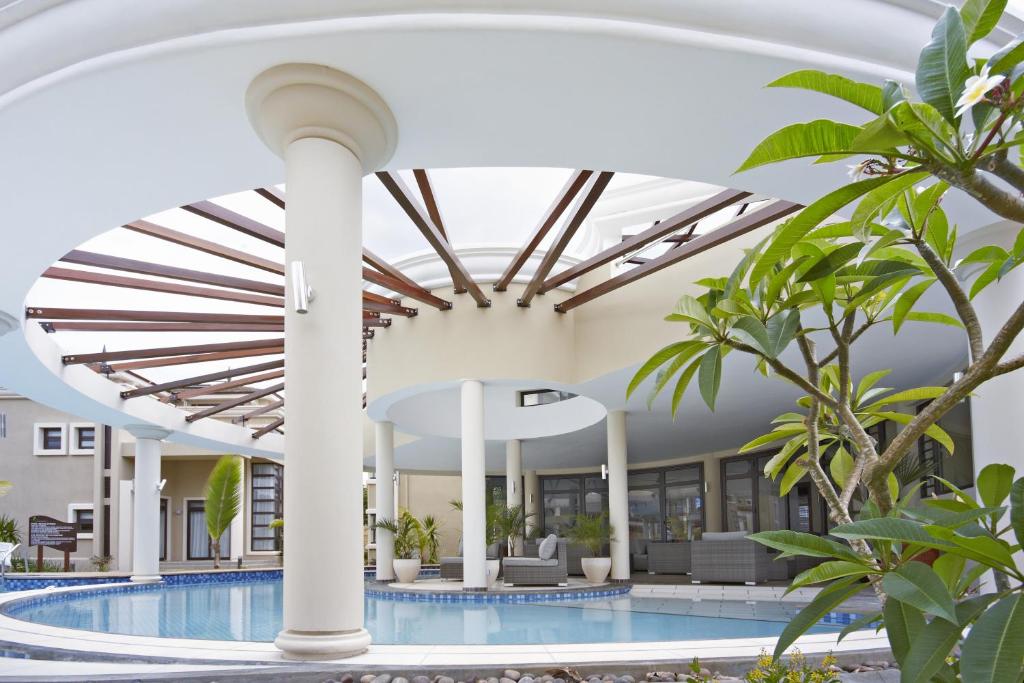 an image of a swimming pool in a hotel with a ceiling at Villasun Luxury Apartments & Villas in Flic-en-Flac