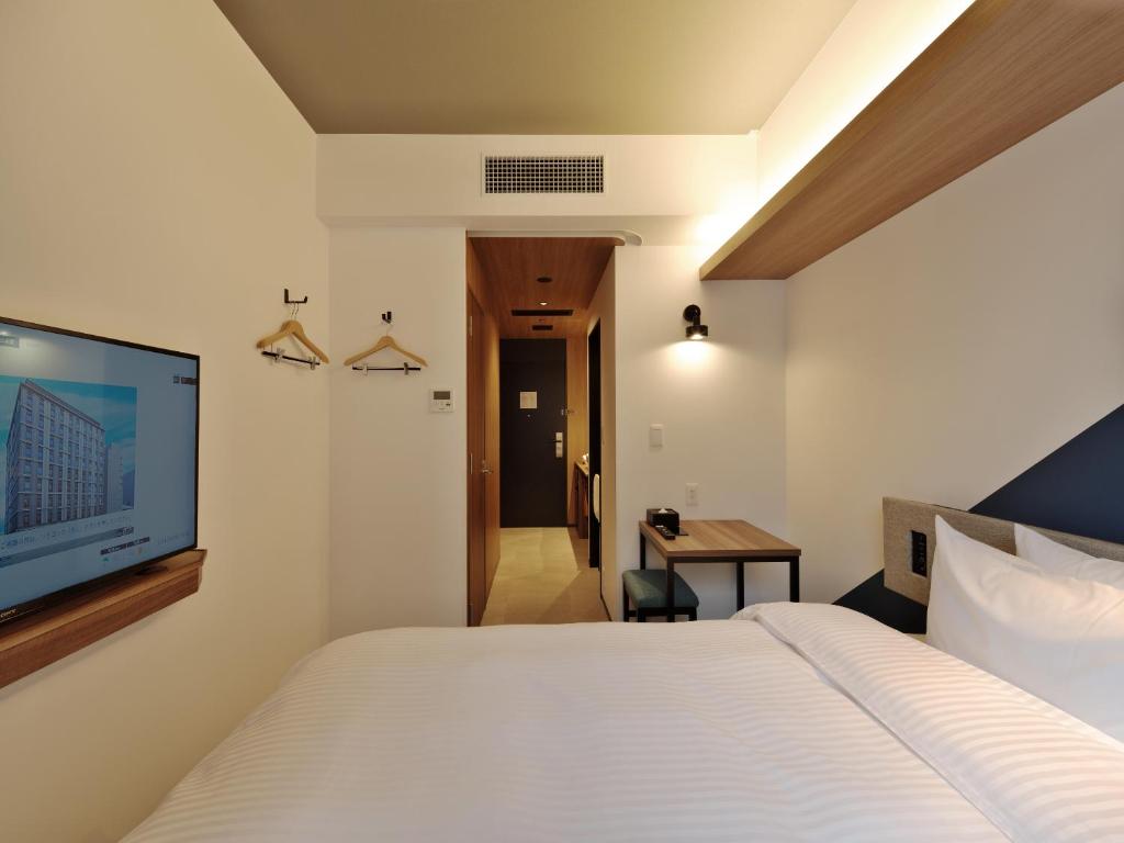 Postel nebo postele na pokoji v ubytování Prince Smart Inn Kyoto Shijo Omiya