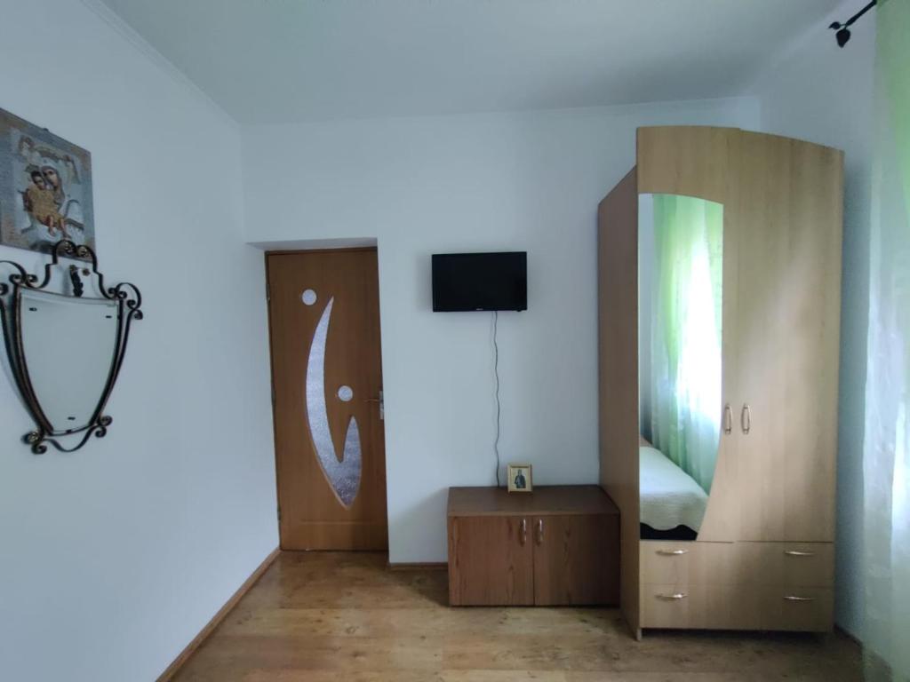 una camera con specchio, letto e TV di Casa Tenciu a Sînpetru