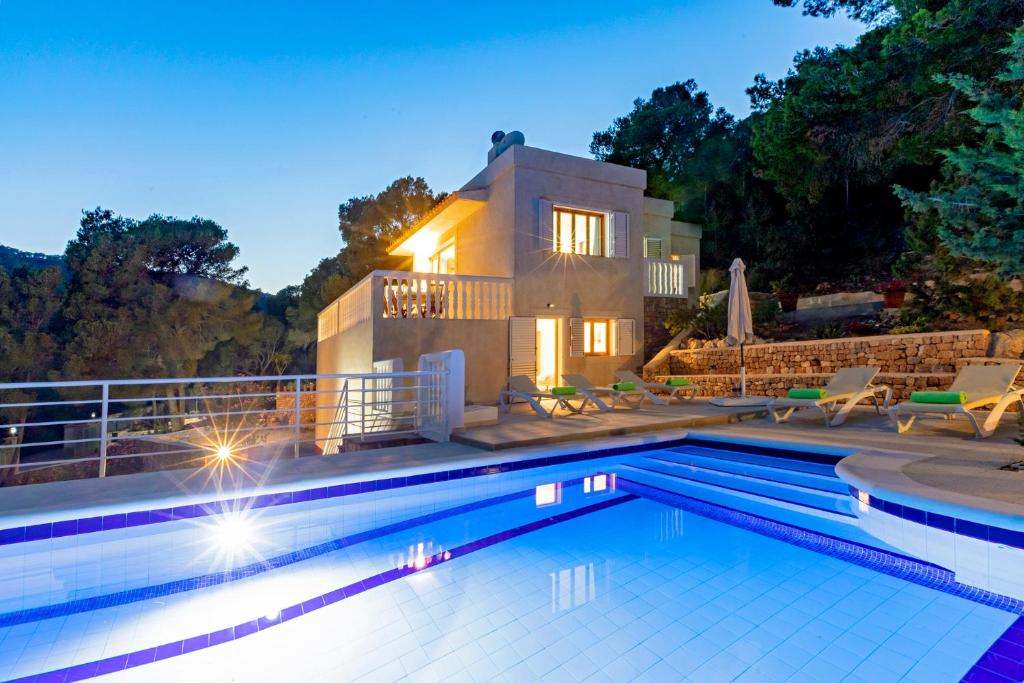 a swimming pool in front of a house at Villa in Ibiza Town, sleeps 6 - Can Damia in Sant Jordi