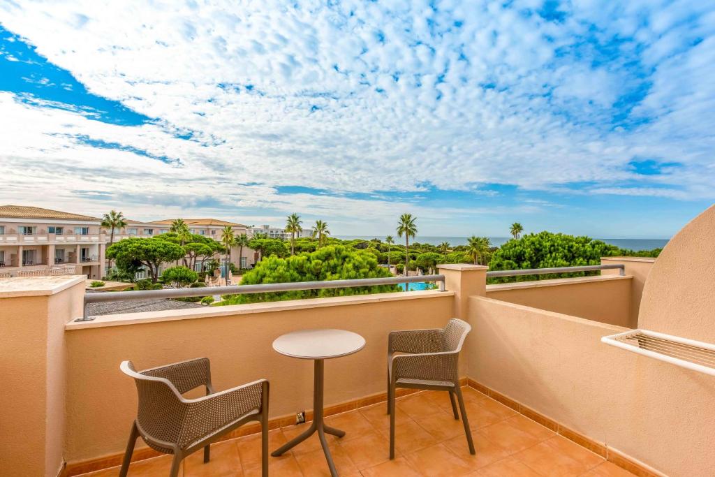 a balcony with a table and chairs and a view at Valentin Sancti Petri in Chiclana de la Frontera