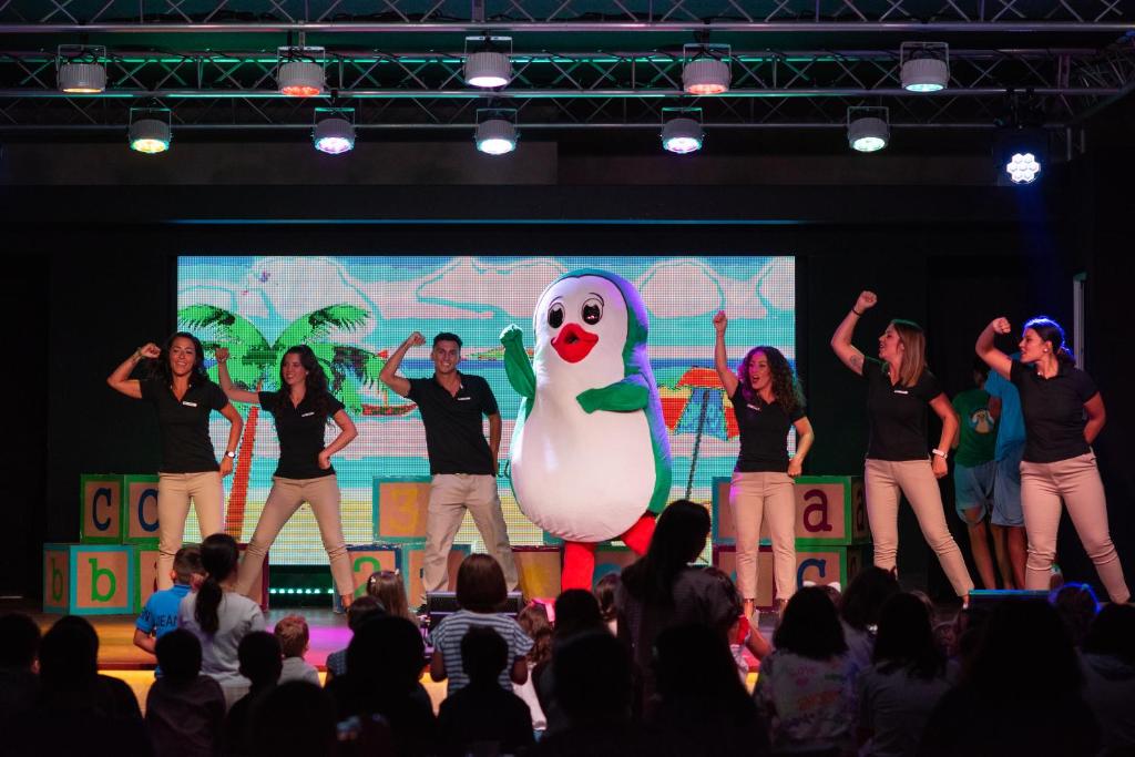 a group of people standing on a stage with a performance at Valentin Sancti Petri in Chiclana de la Frontera