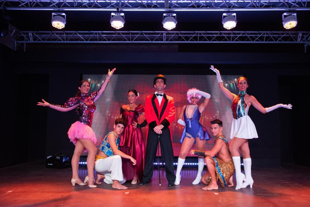 a group of people on the stage in fancy costumes at Valentin Sancti Petri in Chiclana de la Frontera