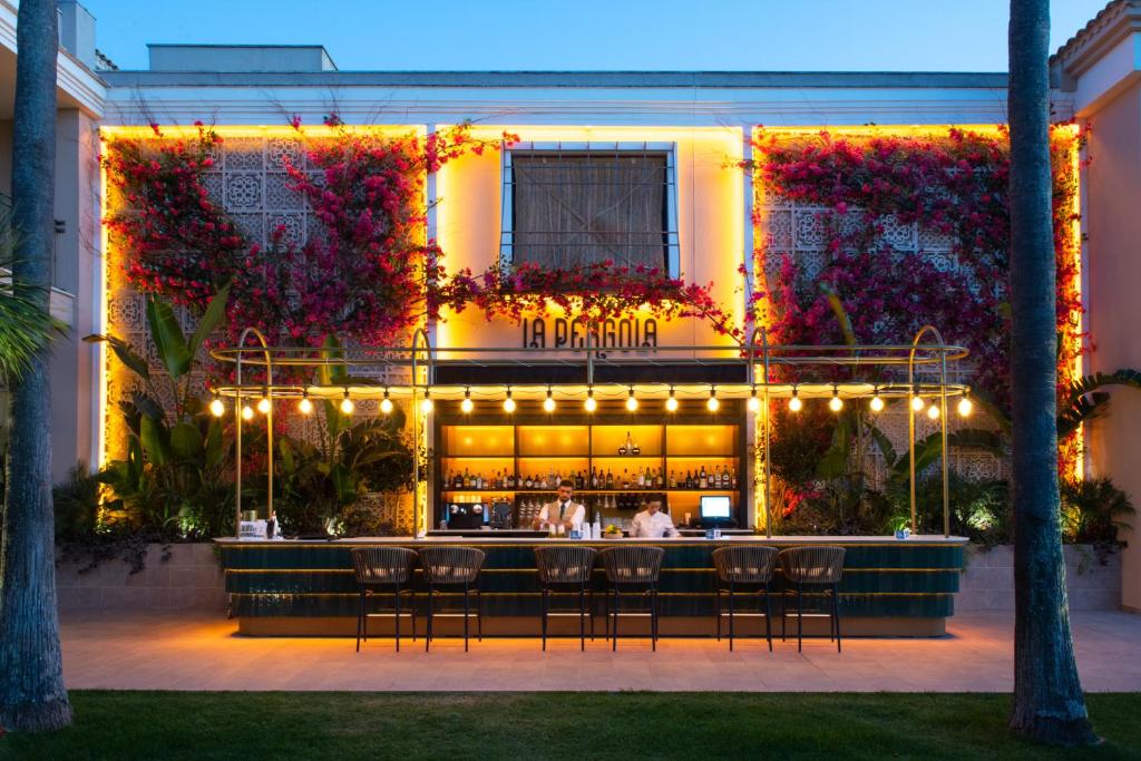 a restaurant with a bar in front of a building at Valentin Sancti Petri in Chiclana de la Frontera