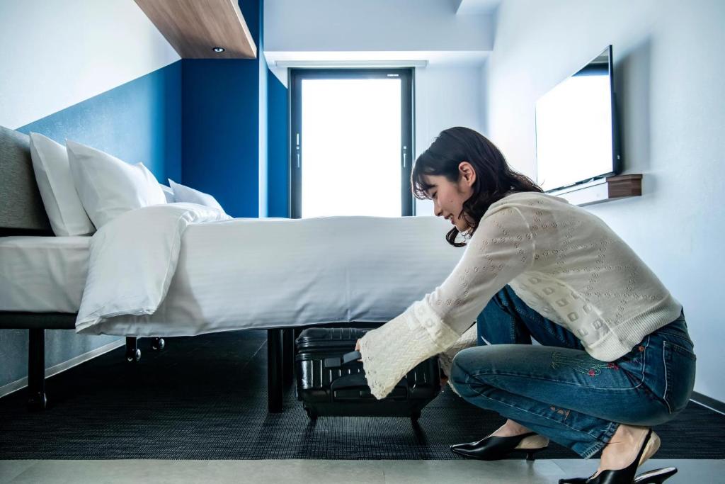 Postel nebo postele na pokoji v ubytování Prince Smart Inn Kyoto Shijo Omiya