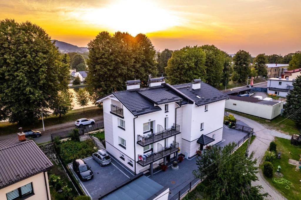an aerial view of a white house with a sunset in the background at Nad Stawem in Ustroń