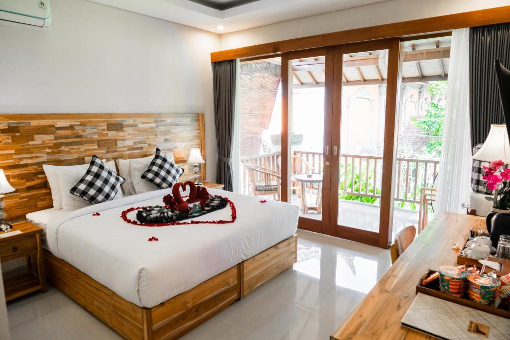 Postel nebo postele na pokoji v ubytování Ari Cottages Ubud