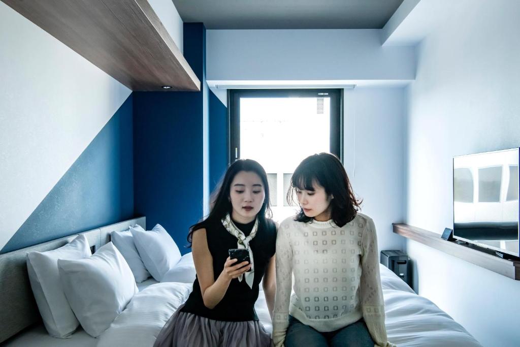 Postel nebo postele na pokoji v ubytování Prince Smart Inn Kyoto Shijo Omiya
