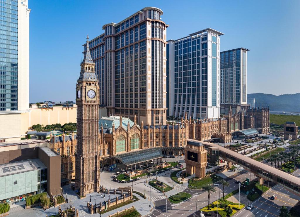 uma cidade com uma torre de relógio em frente aos edifícios em The Londoner Macao em Macau
