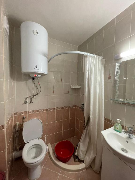 a bathroom with a toilet and a sink at Apartment Sanik in Varna City