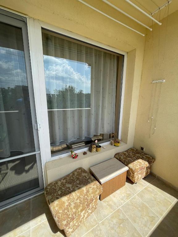 a room with two couches and a large window at Apartment Sanik in Varna City