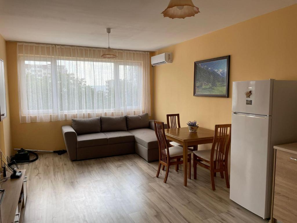 a living room with a couch and a table at Apartment Sanik in Varna City