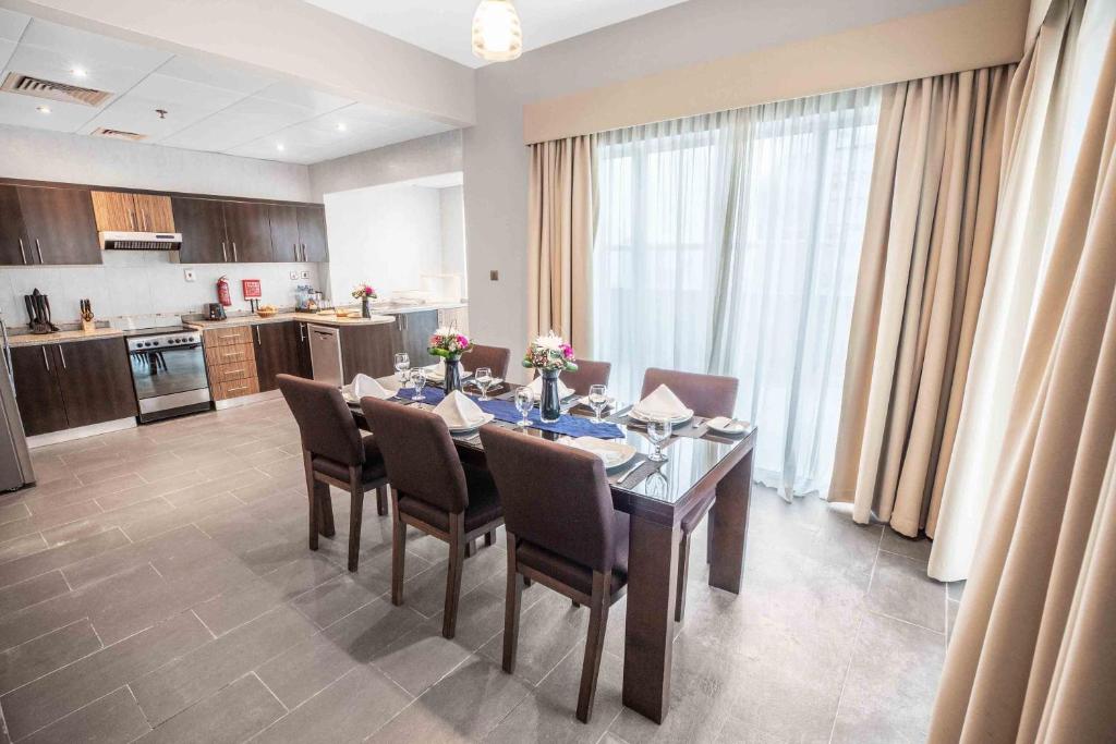 a dining room with a table and chairs in a kitchen at City Premiere Hotel Apartments - Dubai in Dubai