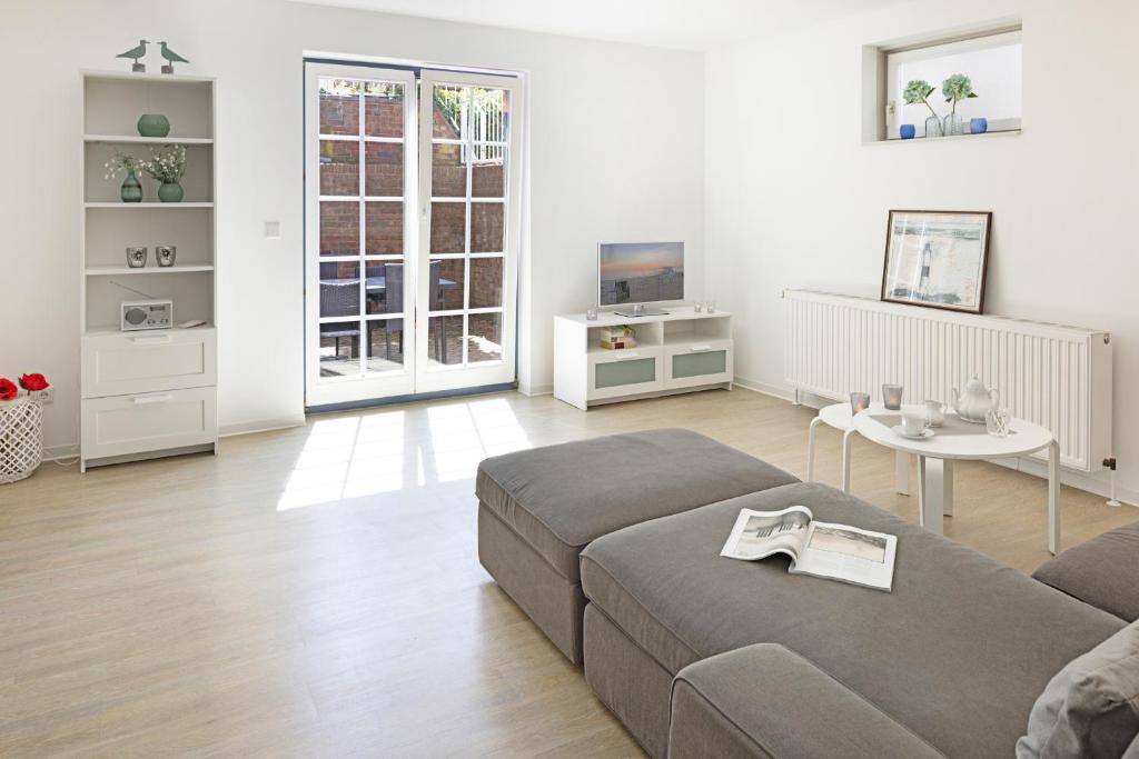 a living room with a couch and a table at Cap Blanco in List