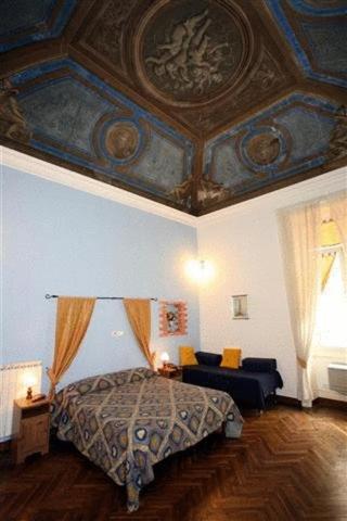 a bedroom with a bed and a coffered ceiling at Family Hotel Balbi in Genoa
