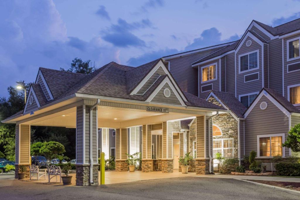 a house with a gambrel roof at Microtel Inn & Suites by Wyndham Jacksonville Airport in Jacksonville